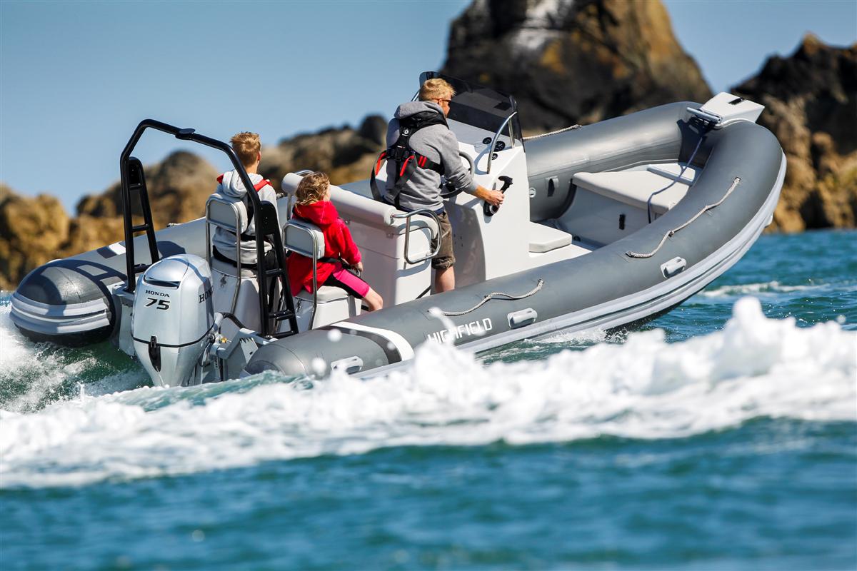 Rigid inflatble with Honda engine dad and two kids